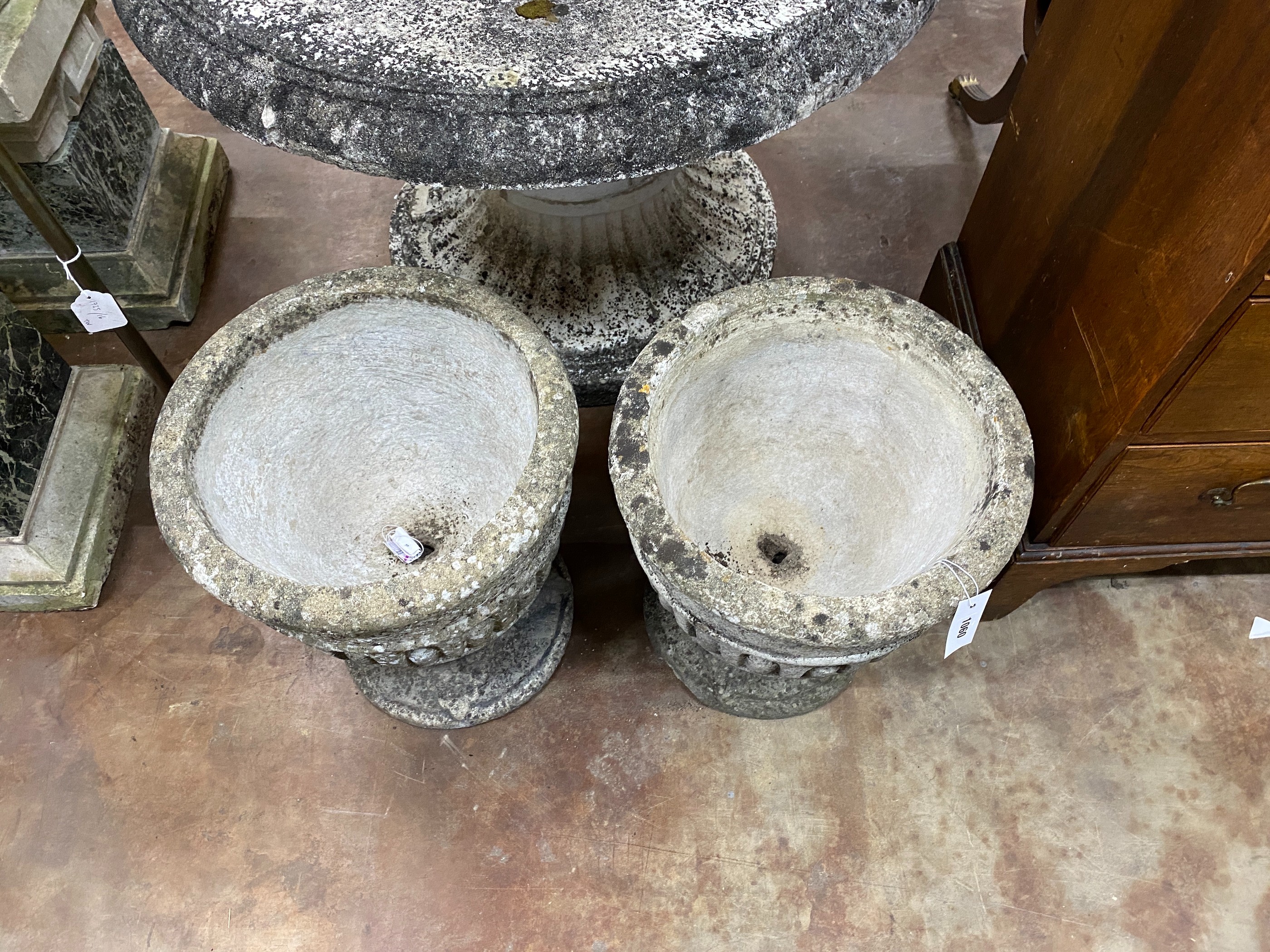 A pair of circular reconstituted stone garden planters, diameter 39cm, height 44cm